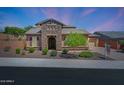 Charming single-story home featuring stone accents, manicured landscaping, and a welcoming front entrance at 25449 N 102Nd Dr, Peoria, AZ 85383