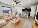 Inviting living room open to a kitchen features a plush sofa, stylish decor, and abundant natural light at 2820 E James Ave, San Tan Valley, AZ 85143