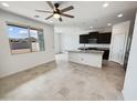 Bright living space with an island countertop, with modern lighting, and easy access to the kitchen and dining areas at 2820 E James Ave, San Tan Valley, AZ 85143