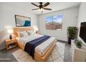 Calm main bedroom with large window, ceiling fan, and neutral tones, offering a relaxing retreat at 2820 E James Ave, San Tan Valley, AZ 85143
