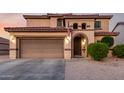 Charming two-story home featuring a two-car garage, well-maintained landscaping, and a tiled roof at 3007 S Calle Noventa --, Mesa, AZ 85212