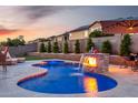 Inviting pool with lit waterfall feature and patio furniture perfect for relaxing evenings at 3007 S Calle Noventa --, Mesa, AZ 85212