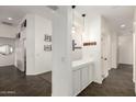 Bright hallway with a built-in storage and decorative accents, offering a seamless transition between rooms at 3354 E Thornton Ave, Gilbert, AZ 85297