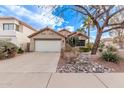 Inviting single-story home with a two-car garage, desert landscaping, and a peaceful residential street view at 3505 E South Fork Dr, Phoenix, AZ 85044
