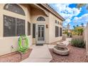 Close up of front entrance featuring a charming courtyard, desert landscaping, and cozy outdoor seating area at 3505 E South Fork Dr, Phoenix, AZ 85044
