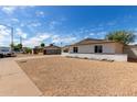 Traditional home featuring desert landscaping, clear blue skies, and a welcoming neighborhood at 3826 W Davidson Ln, Phoenix, AZ 85051