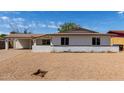 Inviting single-story home with a low brick wall, desert landscaping, and a covered carport at 3826 W Davidson Ln, Phoenix, AZ 85051