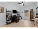 Home office with a ceiling fan and comfortable desk setup at 40365 W Bravo Dr, Maricopa, AZ 85138
