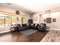 Inviting living room with wood floors, cozy sofas, and large windows offering plenty of natural light and backyard views at 4667 E County Down Dr, Chandler, AZ 85249