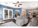 Comfortable living room with wood floors, a cozy sectional sofa, and french doors leading to a backyard or patio area at 4667 E County Down Dr, Chandler, AZ 85249
