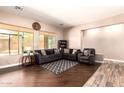 Comfortable living room featuring dual sofas, a large window, and hardwood floors at 4667 E County Down Dr, Chandler, AZ 85249