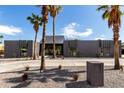 Contemporary home with striking architectural details, desert landscaping, a metal roof and a circular driveway at 5111 E Cortez Dr, Scottsdale, AZ 85254