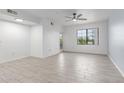 Bright living room showcasing tile flooring, a ceiling fan, and natural light from the window at 5302 E Van Buren St # 2015, Phoenix, AZ 85008