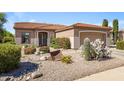 Beautiful front yard with desert landscaping, rocks, and vibrant blooming shrubs at 5332 S Citrus Ct, Gilbert, AZ 85298
