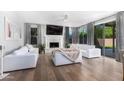 Bright living room with hardwood floors, fireplace, and sliding glass doors to the backyard at 702 W Mountain Sky Ave, Phoenix, AZ 85045