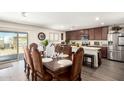 Elegant dining room with ornate table set, flowing to kitchen with stainless steel appliances at 7112 N 126Th Ln, Glendale, AZ 85307