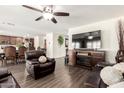 Cozy living room with a modern fireplace, hardwood floors, and an open floor plan at 7112 N 126Th Ln, Glendale, AZ 85307