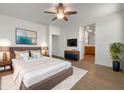 Relaxing main bedroom featuring a cozy bed with a plush rug, soft lighting and ensuite bathroom access at 7146 E Bobwhite Ct, San Tan Valley, AZ 85143