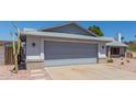 Two car garage with neutral tone, matching the exterior of the home at 8020 W Windrose Dr, Peoria, AZ 85381
