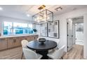Bright dining room boasting an elegant light fixture, built-in cabinets and backyard views at 8117 E Lewis Ave, Scottsdale, AZ 85257