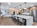 Spacious kitchen featuring a large island with bar seating, modern appliances, and sleek cabinetry at 8117 E Lewis Ave, Scottsdale, AZ 85257