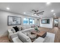 Comfortable living room with a ceiling fan, large windows, plush seating, and stylish decor at 8117 E Lewis Ave, Scottsdale, AZ 85257