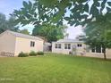 Spacious backyard featuring a detached garage and a lush green lawn at 930 W Mackenzie Dr, Phoenix, AZ 85013