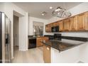 Well-lit kitchen with stainless steel appliances, wood cabinets, and a breakfast bar at 1024 E Frye Rd # 1090, Phoenix, AZ 85048