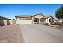 Single-story home featuring a two-car garage, desert landscaping, and a spacious driveway at 11840 N 59Th Ln, Glendale, AZ 85304