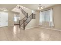 Inviting entryway showcases tile flooring and a staircase, illuminated by natural light through the windows at 121 W Hackberry Dr, Chandler, AZ 85248