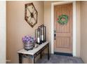 Charming front entryway with decorative wreath, lanterns, and desert-themed table at 12780 W Desert Vista Trl, Peoria, AZ 85383