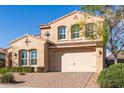 Charming two-story home features a tile roof, stucco finish, arched windows, and a paved driveway at 13212 W Whisper Rock Trl, Peoria, AZ 85383