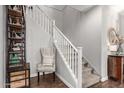 Bright staircase with white railing and carpeted stairs, complemented by decorative shelving and hardwood flooring at 13212 W Whisper Rock Trl, Peoria, AZ 85383