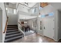 Light-filled foyer with staircase, high ceilings, and tile flooring, showcasing an open layout at 1381 N Alexis Dr, Gilbert, AZ 85234