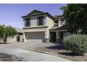 Two-story home featuring desert landscaping, attached two-car garage and neutral stucco at 1390 E Kingman Pl, Casa Grande, AZ 85122