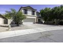 Charming two-story home with neutral stucco, shutters, landscaping, and a wide driveway at 1390 E Kingman Pl, Casa Grande, AZ 85122