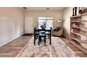 Bright dining area featuring wood floors, a window view, and stylish decor at 14578 W Evans Dr, Surprise, AZ 85379