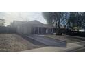Well-maintained home featuring a cozy, covered porch, a mature shade tree, and low maintenance front yard at 14620 N 31St Ln, Phoenix, AZ 85053