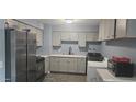 Modern kitchen with stainless steel appliances, including a refrigerator and a stove at 14620 N 31St Ln, Phoenix, AZ 85053
