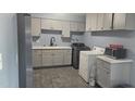 Well-organized laundry room with washer, dryer, microwave, and ample storage space at 14620 N 31St Ln, Phoenix, AZ 85053