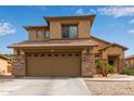 Two-story home featuring a 2-car garage, desert landscaping, and a neutral color scheme at 15429 W Statler Cir, Surprise, AZ 85374