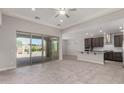 Open-concept living area with tile flooring, connecting seamlessly to the kitchen and featuring large sliding glass doors at 15899 S 183Rd Dr, Goodyear, AZ 85338
