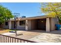 Single-story home featuring a convenient carport, neat landscaping, and secure gated entrance for added privacy at 1617 W Vineyard Rd, Phoenix, AZ 85041