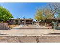 Charming single-story home featuring a secure gated entrance and covered carport, offering privacy and convenience at 1617 W Vineyard Rd, Phoenix, AZ 85041