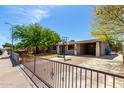 Inviting single-story home featuring a secure gated entrance and a convenient carport perfect for shade at 1617 W Vineyard Rd, Phoenix, AZ 85041