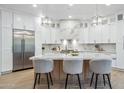 Gourmet kitchen with marble countertops, stainless steel appliances, a large island, and elegant pendant lighting at 16389 N 108Th Pl, Scottsdale, AZ 85255