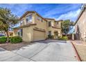 Front view of two-story home with landscaping, garage, and driveway on a sunny day at 17374 W Adams St, Goodyear, AZ 85338
