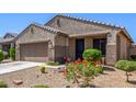 Inviting single-story home with desert landscaping adding charm to its well-maintained exterior at 18008 W Tina Ln, Surprise, AZ 85387