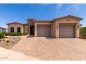 Inviting single-story home with a two car garage and a brick driveway at 2111 N Piper Pl, Mesa, AZ 85215