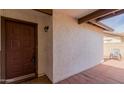 Covered porch area features a brown front door and neutral colored brick at 2524 W Kiva Ave, Mesa, AZ 85202